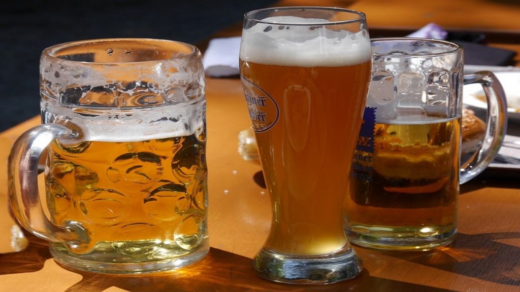 A pint, mug, and glass of German beers sitting on the table