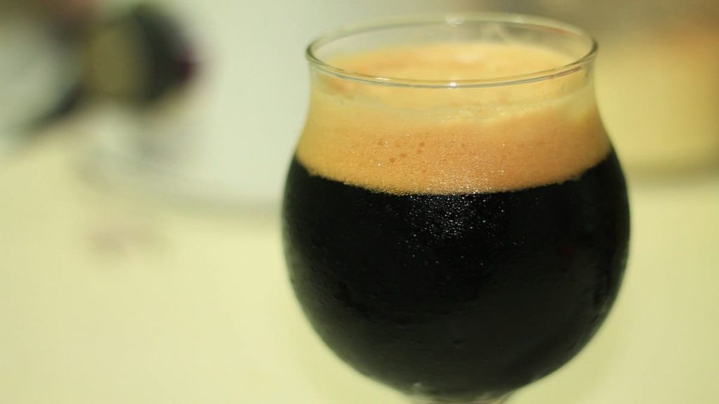 A chilled and frothy glass of stout beer